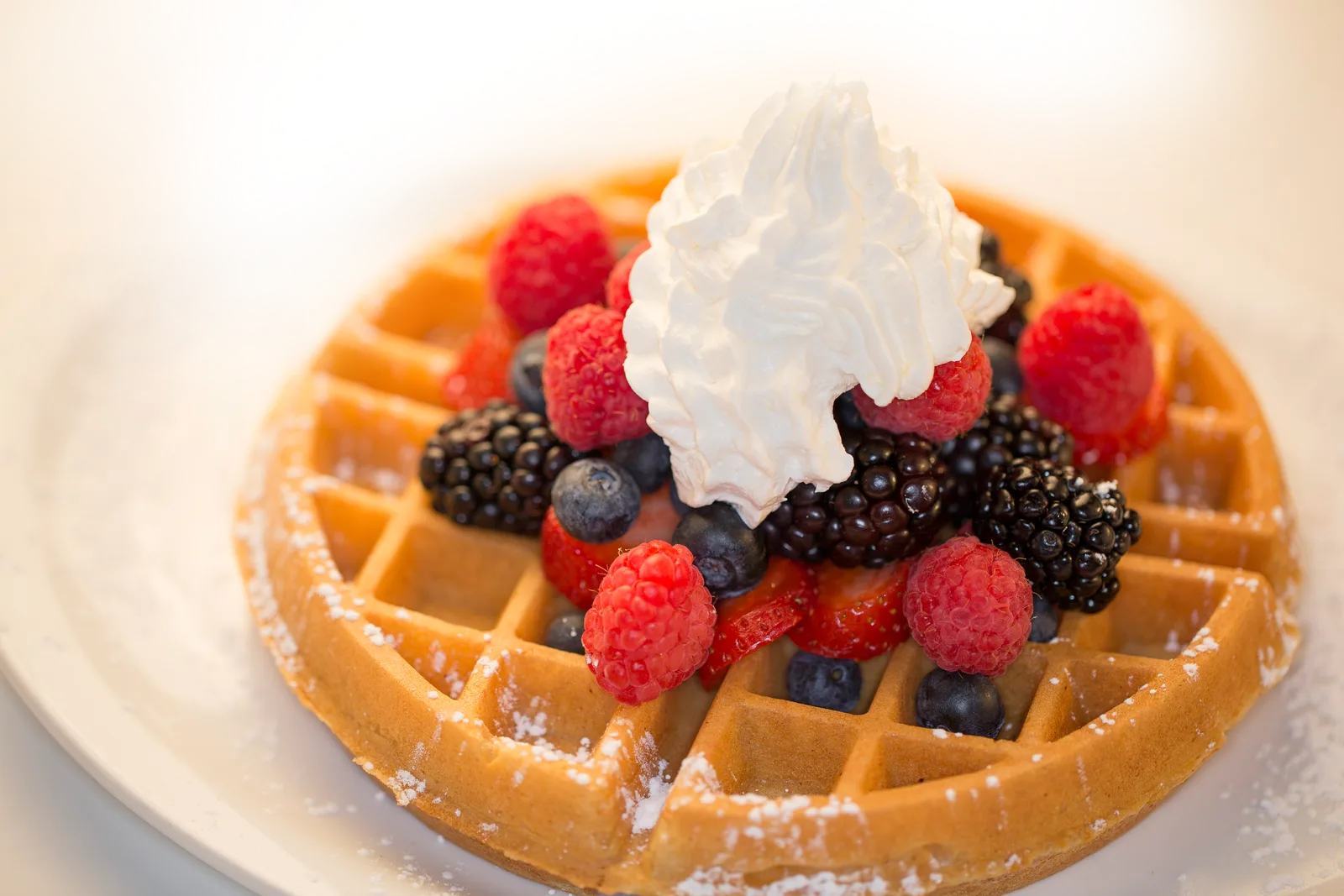 Waffle with berries and whipped cream